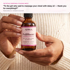 Hands holding FullBloom bust oil
